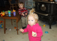 The twins control the kitchen. Theodore leans comfortably on the table. That's my favorite wood stove of all time in the background.