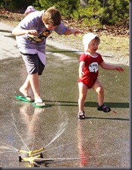 Theodore high steps his way through the water and away from his scary brother. The boss's hat can be seen in the background.