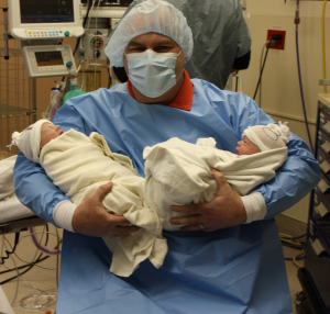 Dad holding Baby A and Baby B