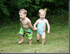 Happy twins holding hands