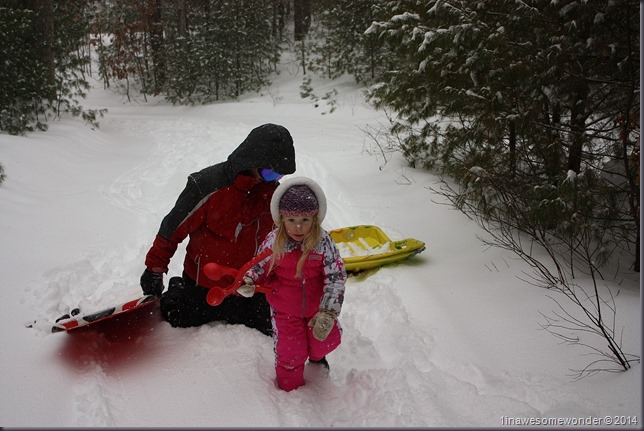 Snowflakes fall as Jacqueline walks away from her sled, and driver, Sebastian