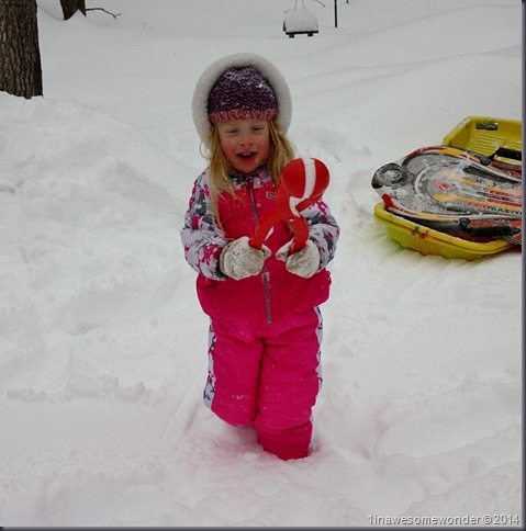 Jacqueline makes a perfect snowball for Dad