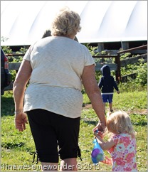 Aunt Janette leads Jacqueline up to see the calves.