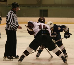 Noah Charron digs in for a faceoff against Windham. (c) 1inawesomewonder. (Photo by Charron)
