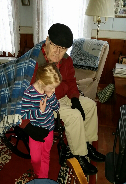 Dad and Jacqueline warm up by the stove on Feb. 8th, 2016. (c) 1inawesomewonder